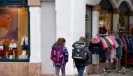 School children are on their way home in the commune of Kuchl, south of Salzburg, Austria, on October 15, 2020, during the ongoing novel coronavirus (Covid-19) pandemic. From October 17, Kuchl will be put under lockdown to curb the spread of the coronavir