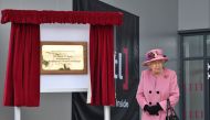 Britain's Queen Elizabeth II (R) is seen after she unveiled a plaque to officially open the new Energetics Analysis Centre at the Defence Science and Technology Laboratory (Dstl) at Porton Down science park near Salisbury, southern England, on October 15,