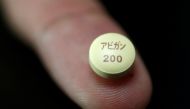 A tablet of Avigan - drug approved as an anti-influenza drug in Japan and developed by Toyama Chemical Co, a subsidiary of Fujifilm Holdings Co, is displayed during a photo opportunity at Fujifilm's headquarters in Tokyo, October 22, 2014. REUTERS/Issei K