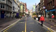 A person wears a face mask as they walk through the city centre as the coronavirus disease (COVID-19) outbreak continues in Cardiff, Wales, Britain October 19, 2020. REUTERS/Rebecca Naden