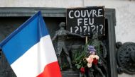 A placard against the late-night curfew is seen on the Republique statue, following the restrictions against the spread of the coronavirus disease (COVID-19) in Paris, France, October 18, 2020. REUTERS/Charles Platiau
