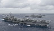 (FILES) In this file photo taken on July 18, 2017 this US Navy handout photo obtained July 18, 2017 shows the aircraft carrier USS Nimitz (CVN 68)as it leads a formation of ships from the Indian navy, Japan Maritime Self-Defense Force (JMSDF) and the US N