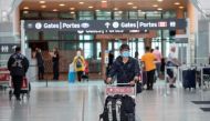FILE PHOTO: A passengers wears a mask which is now mandatory as a 