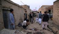 Residents gather at a site following a suicide bomber blew himself up in an education centre, in Kabul on October 24, 2020. A suicide bomber struck near an education centre in the Afghan capital on October 24, killing at least 18 people in the latest atta