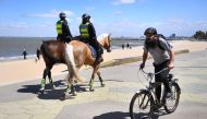 Police patrol on horseback along the St Kilda Esplanade in Melbourne on October 26, 2020 as Australian health officials reported no new coronavirus cases or deaths in Victoria state, which has spent months under onerous restrictions after becoming the epi