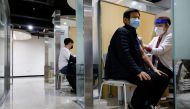 A man gets an influenza vaccine at a branch of the Korea Association of Health Promotion in Seoul, South Korea, October 23, 2020. REUTERS/Kim Hong-Ji
