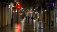 People walk along an empty street during the first day of the night-time curfew set as part of a state of emergency in an effort to control the outbreak of the coronavirus disease (COVID-19), in downtown Ronda, southern Spain late October 25, 2020. REUTER