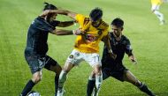 This handout photo taken on October 28, 2020 and received on October 29 from the Philippine Football League (PFL) shows Jason Panhay (C) of Kaya FC-Iloilo being tackled by players from Maharlika Manila FC during their Philippine Football League football m