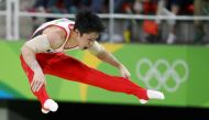 Kohei Uchimura (JPN) of Japan competes on the parallel bars during the men's individual all-around final. REUTERS/Kai Pfaffenbach