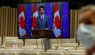 Prime Minister of Canada Justin Trudeau on a screen speaks during a joint press conference with European Council President following a virtual EU - Canada Summit in Brussels, on October 29, 2020. / AFP / EPA / Olivier Hoslet 