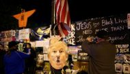 A mask depicting U.S President Donald Trump is seen as Supporters of U.S. Democratic presidential nominee Joe Biden gather near the White House during Election Day in Washington, U.S., November 3, 2020. REUTERS/Hannah McKay
