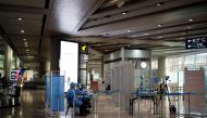 Staff members in protective suits sit at a checkpoint at Beijing Capital International Airport, following new cases of the coronavirus disease (COVID-19) infections, in Beijing, China June 16, 2020. REUTERS/Carlos Garcia Rawlins/File Photo
