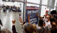 TOPSHOT - Supporters of US President Donald Trump bang on the glass and chant slogans outside the room where absentee ballots for the 2020 general election are being counted at TCF Center on November 4, 2020 in Detroit, Michigan. Democratic presidential c