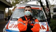 Paramedic Marcin Serwach, 35, attends an interview with Reuters amid the global outbreak of the coronavirus disease (COVID-19), at a cemetery in Warsaw, Poland, November 4, 2020. REUTERS/Kacper Pempel
