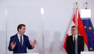 Austria's Health Minister Rudolf Anschober listens as Chancellor Sebastian Kurz speaks during a news conference, as the spread of the coronavirus disease (COVID-19) continues, in Vienna, Austria October 31, 2020. REUTERS/Leonhard Foeger