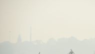 Commuters are seen amid heavy smog conditions and fog, in Allahabad on November 6, 2020. / AFP / SANJAY KANOJIA