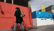 An Iranian woman wearing a face mask walks outdoors in Tehran, Iran November 8, 2020. Majid Asgaripour/WANA 