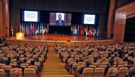 Syria's President Bashar al-Assad (on screen) addresses via video link the opening session of the international conference on the return of refugees held in Damascus on November 11, 2020. / AFP / LOUAI BESHARA