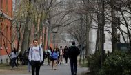 FILE PHOTO: Students and pedestrians walk through the Yard at Harvard University in Cambridge, Massachusetts, U.S., March 10, 2020. REUTERS/Brian Snyder/File Photo
