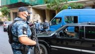 Lebanese policemen check cars at a checkpoint in the Sanayeh district of the Lebanese capital Beirut a day after the country went into lockdown, in a bid to stem the spread of the novel coronavirus, on November 14, 2020.  AFP / ANWAR AMRO
