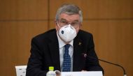 International Olympic Committee President Thomas Bach wears a face mask as he speaks during a news conference in Tokyo, Japan November 16, 2020. Carl Court/Pool via REUTERS