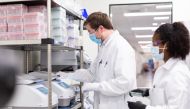 Researchers work in a lab run by Moderna Inc, who said November 16, 2020 that its experimental vaccine was 94.5% effective in preventing COVID-19 based on interim data from a late-stage clinical trial, in an undated photograph. Moderna Inc/Handout via REU