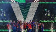 Karachi Kings' cricketers celebrate with the trophy after winning the Pakistan Super League (PSL) Twenty20 cricket final match between the Karachi Kings and Lahore Qalandars at the National Stadium in Karachi on November 17, 2020. / AFP / Asif HASSAN
