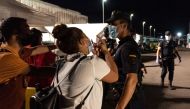 Sarah Bettache requests a Spanish National Police officer to help her find her brother Ahmed, a 19-year-old migrant from Morocco, in the port of Arguineguin, Gran Canaria, Spain November 16, 2020. REUTERS/Eduardo Robaina/La Marea
