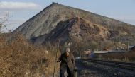FILE PHOTO: An elderly villager walks along a railway line on the outskirts of Jixi, in Heilongjiang province, China, October 24, 2015. REUTERS/Jason Lee/File Photo
