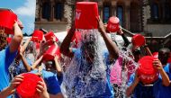 FILE PHOTO: Eleven-year-old Jahziyah Jones, with a crowd of others, pours a bucket of ice water over her head during an event to commemorate the five year anniversary of the 