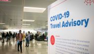Travelers wait for their luggage at Newark International Airport on November 21, 2020 in Newark, New Jersey. Current US numbers -- more than a quarter of a million deaths have been reported -- have alarmed authorities enough to advise that people stay hom