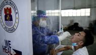 File photo: A vendor at Pritil Public Market gets a free swab test amid the coronavirus disease (COVID-19) outbreak, in Tondo, Manila, Philippines, October 8, 2020. Reuters/Eloisa Lopez/File Photo