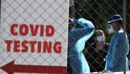 Healthcare workers are seen at a walk-up Covid-19 testing site, November 24, 2020, in San Fernando, California, just northeast of the city of Los Angeles. AFP / Robyn Beck
