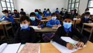 Students wear protective masks as they attend a class at school as the outbreak of the coronavirus disease (COVID-19) continues, in Peshawar, Pakistan November 23, 2020. REUTERS/Fayaz Aziz
