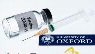 This illustration picture taken in Paris on November 23, 2020 shows a syringe and a bottle reading 