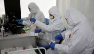 File photo: People wearing protective coverall work at the drive-thru testing centre on the coronavirus disease (COVID-19) in Warsaw, Poland, October 2, 2020. Reuters/Kacper Pempel/File Photo