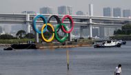 Boats tow the giant Olympic rings, which are being temporarily removed for maintenance, amid the coronavirus disease (COVID-19) outbreak, at the waterfront area at Odaiba Marine Park in Tokyo, Japan August 6, 2020. REUTERS/Kim Kyung-Hoon/File Photo