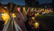 People watch movies from tents placed for social distancing at the campsites in Bandung, West Java Province, Indonesia, November 4, 2020. Picture taken November 4, 2020, in this photo taken by Antara Foto/M Agung Rajasa via Reuters