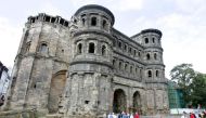 File Photo: Tourist in front of Trier's most famous monument, the Porta Nigra, or Black Gate.  AFP / John MACDOUGALL
