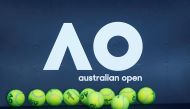 Tennis balls are pictured in front of the Australian Open logo before the tennis tournament. REUTERS/Thomas Peter/File Photo