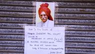 A sign with a picture of Mahashian Di Hatti (MDH) Spices founder Dharampal Gulati is seen at a closed store in New Delhi on December 4, 2020. A former refugee who became India's 