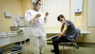 A nurse wearing a face mask proceeds to a vaccination against the coronavirus disease by Sputnik V (Gam-COVID-Vac) vaccine at a clinic in Moscow on December 5, 2020. AFP / Kirill Kudryavtsev 