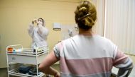 A nurse wearing a face mask proceeds to vaccination against the coronavirus disease (COVID-19) by Sputnik V (Gam-COVID-Vac) vaccine at a clinic in Moscow on December 5, 2020, amid the ongoing coronavirus disease pandemic.  AFP / Kirill KUDRYAVTSEV