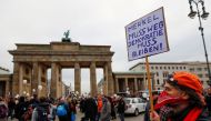 File photo: A demonstrator holds a sign reading 