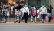 People wearing protective face masks cross a street, in Singapore, November 30, 2020. Reuters/Edgar Su