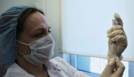 A medical worker fills a syringe with Sputnik V (Gam-COVID-Vac) vaccine before administering an injection during the vaccination against the coronavirus disease (COVID-19) at a clinic in Moscow, Russia December 5, 2020. REUTERS/Maxim Shemetov