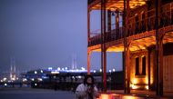 A woman looks at her mobile phone as she walks in Yokohama on December 3, 2020. / AFP / Philip FONG