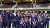 Indian players pose for pictures with the winning Dettol T20 cricket series trophy after the third match between Australia and India at the Sydney Cricket Ground (SCG) in Sydney on December 8, 2020. AFP / David Gray