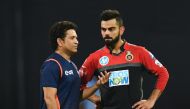 Royal Challengers Bangalore captain Virat Kohli (R) speaks with Mumbai Indians team mentor Sachin Tendulkar before the start of the 2018 Indian Premier League (IPL) Twenty20 cricket match at the Wankhede stadium in Mumbai. Gettyout / AFP / Punit Paranjpe 
