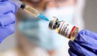 FILE PHOTO: A woman holds a small bottle labeled with a 